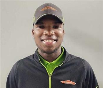 Male employee in front of white wall